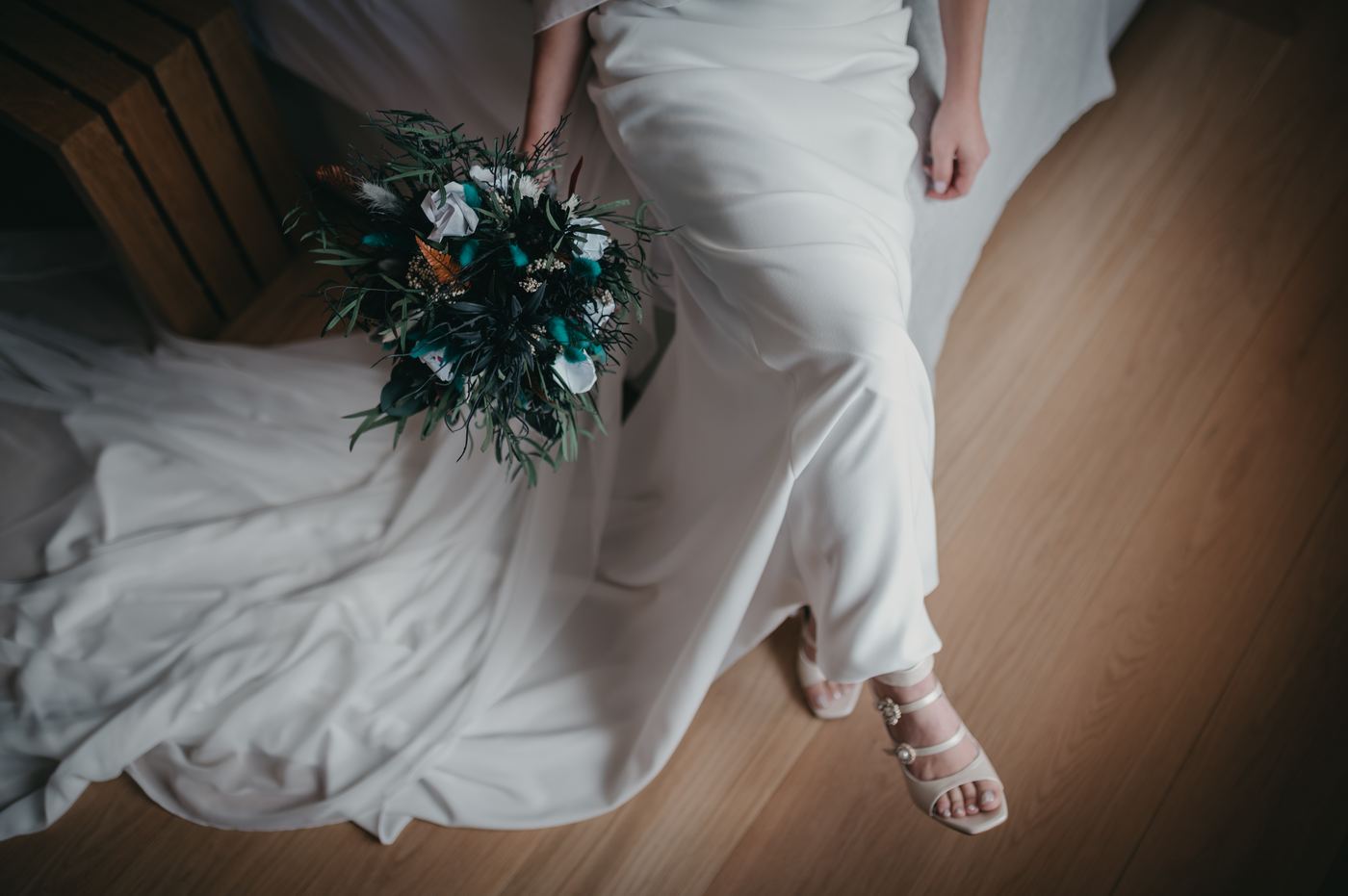 Novia sentada con el ramo durante los preparativos
